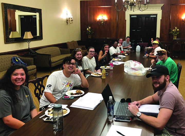 A group of students at a long table. 