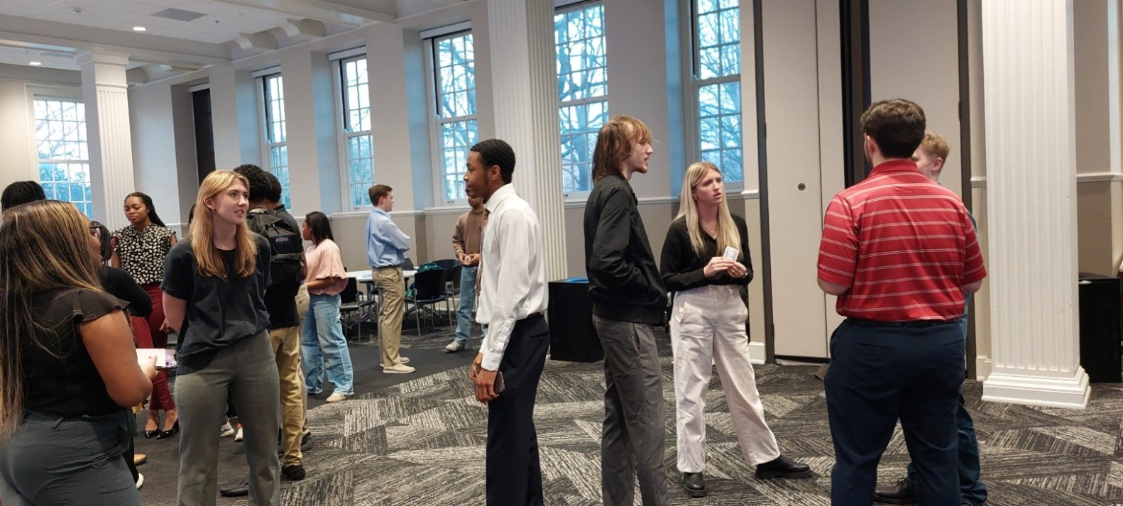 A group of several students standing and talking