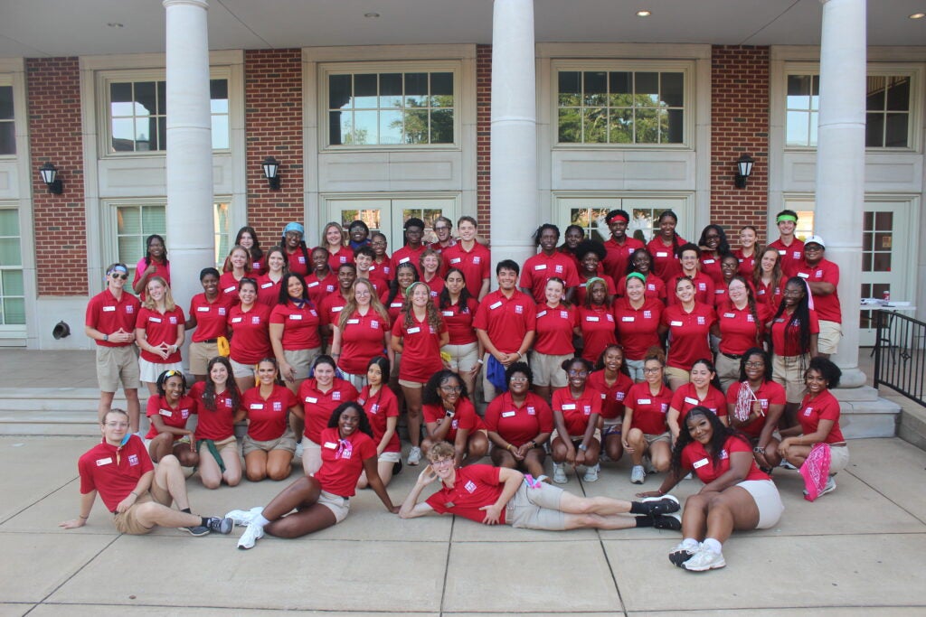 Group of students posing in front of building.