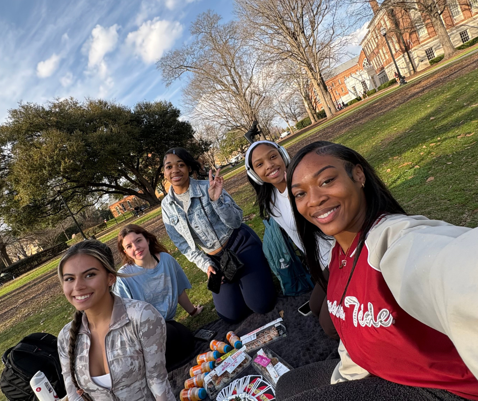 Students take selfie while on a picnic on the Quad