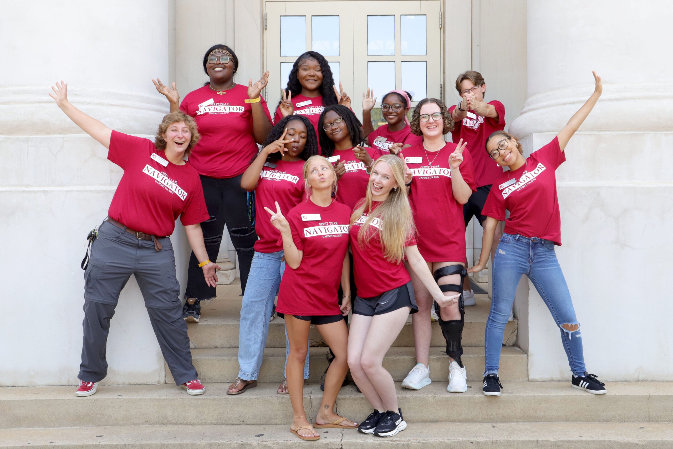 Students posing in front of building. 